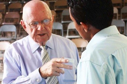 Howard Norton speaks to an attendee at the Baxter Institute's annual seminar in Tegucigalpa in 2011.