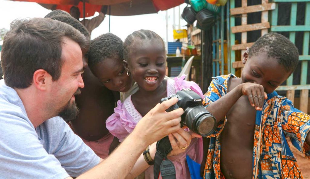 Erik Tryggestad shares a photo and a laugh with children in Burkina Faso.