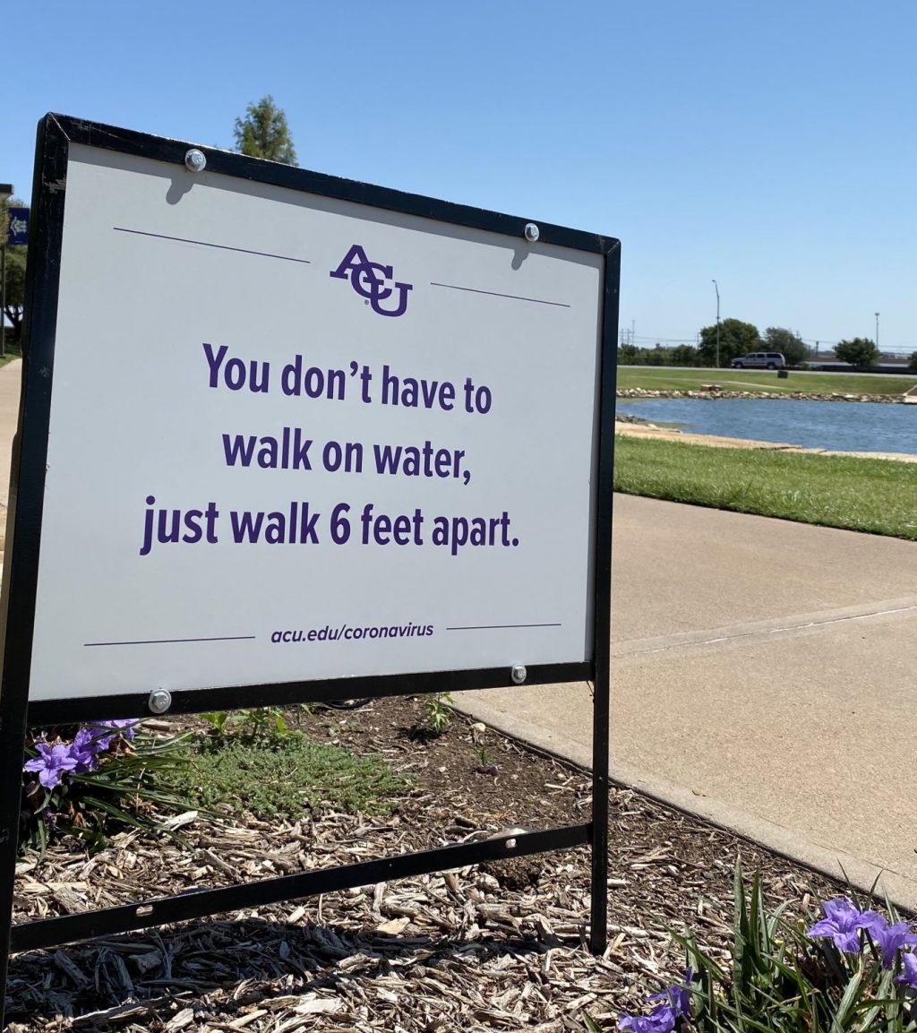 A sign on the campus of Abilene Christian University reminds everyone take safety precautions.