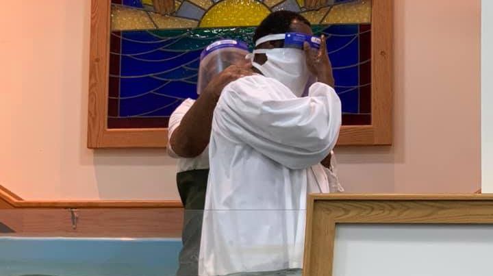 With special attire to prevent the spread of the coronavirus, a man is baptized at the Sharpe Road Church of Christ in Greensboro, N.C.