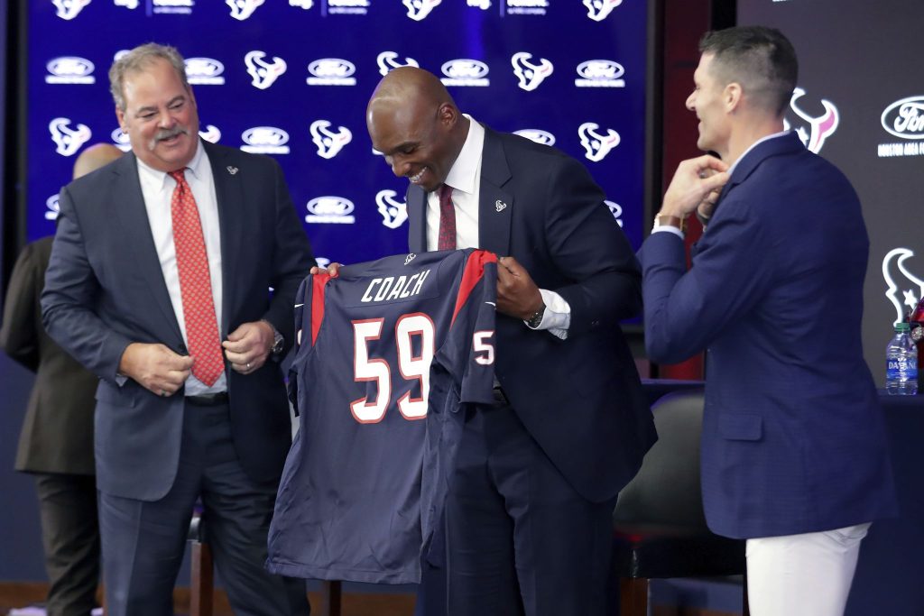 Newly named Houston Texans head coach DeMeco Ryans, center, is presented a jersey by team owner Cal McNair, left, and general manager Nick Caserio, right.