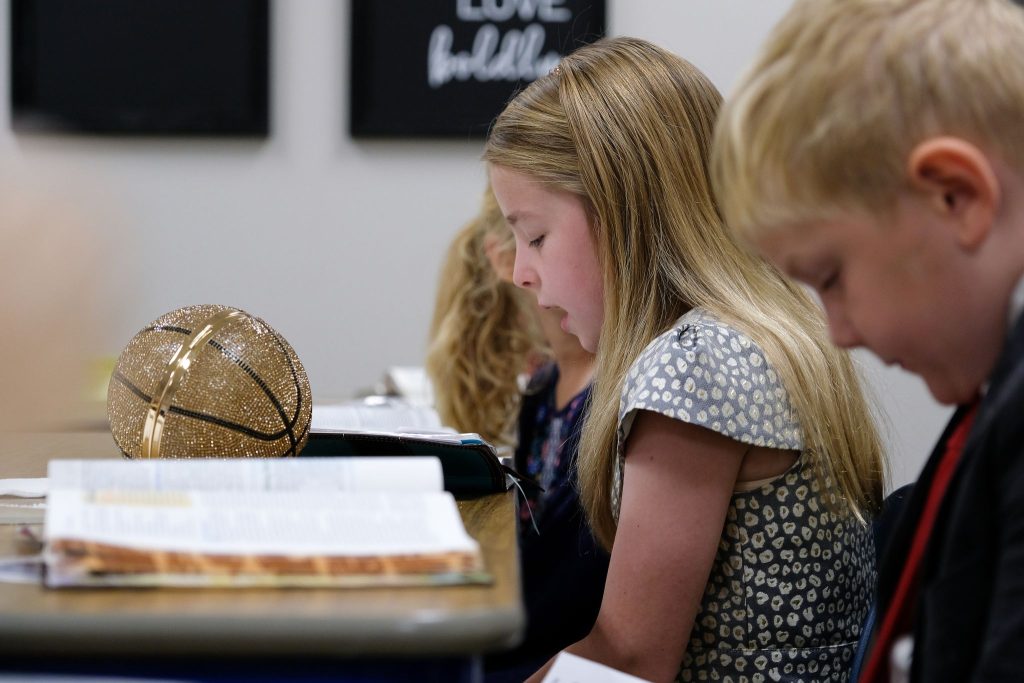 A girl reads Scripture in a Windsong Church of Christ class on a recent Sunday.