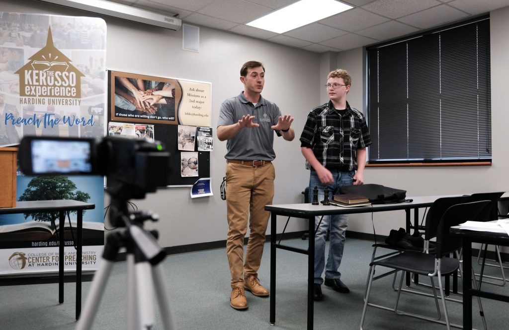 Jared Mayes, left, talks about sermon delivery with Zeke Colston in front of a class.