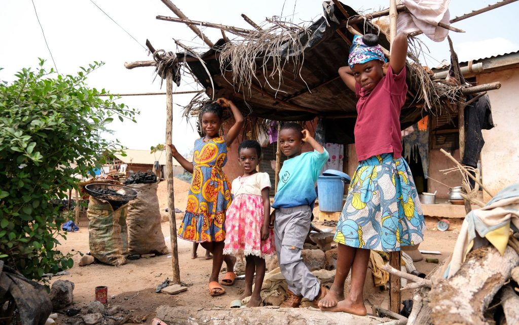 Children who live across from the construction for a girls' boarding school in New Debiso, Ghana, pose for a photo.