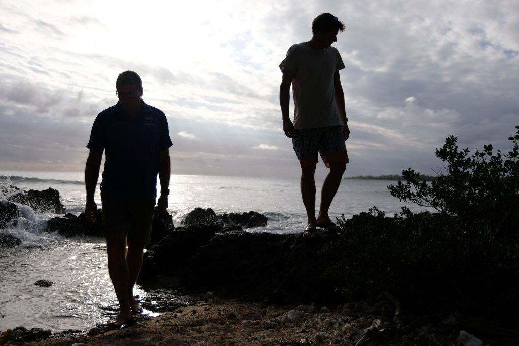 Joel Erkkila and his son-in-law, Josh Pitman, walk along the reef that borders Redlands College's campus in Vanuatu.