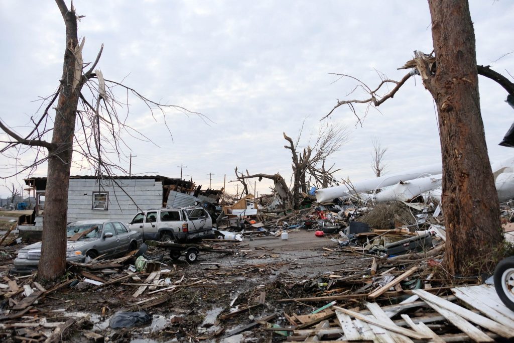 Debris and wrecked vehicles surround a house in Mayfield, Ky., on Jan. 9, 2022. The house was destroyed by the Dec. 10 tornado that left many in the community devastated.