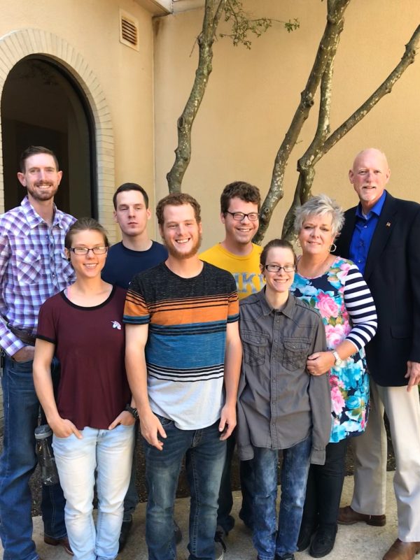 From left, Joshua, Kenedy, Zachary, Jonah, Jacob, Aleksi, Deshonna and Brent Taylor pose for a family photo.