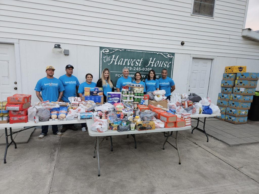 Employees from a local LyondellBassell plant deliver donations to Harvest House.