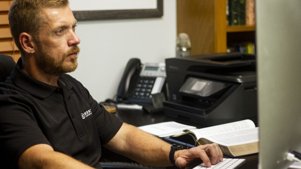 Distance learning student Doug Tooley works on a computer.