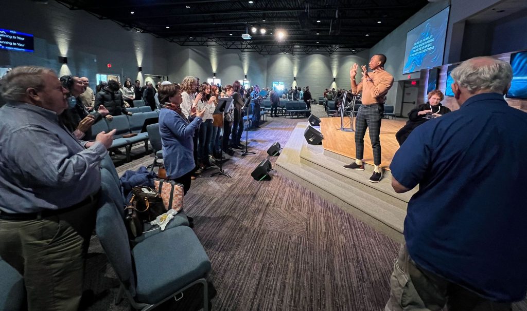 Chris Jackson provides American Sign Language interpretation during a Fairfax Church of Christ worship assembly. Cindi Cesone can be seen on the front row.