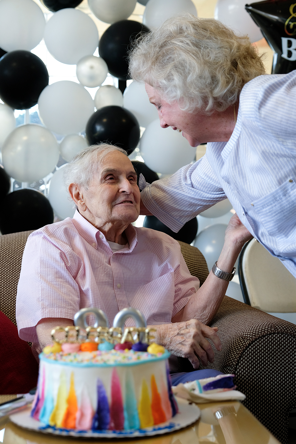 Bailey McBride and Lottie McCormack share a laugh during McBride's 90th birthday party at Oklahoma Christian University.