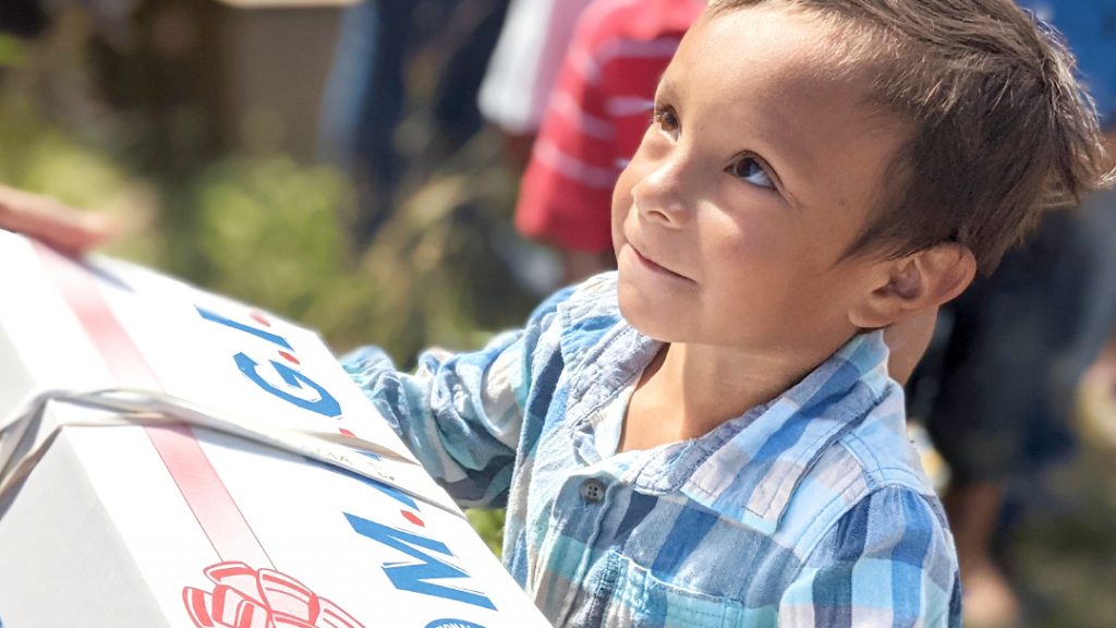 A child in rural Honduras, served by the Mission Lazarus ministry, receives a MAGI box of clothes, toys, hygiene items and school supplies.