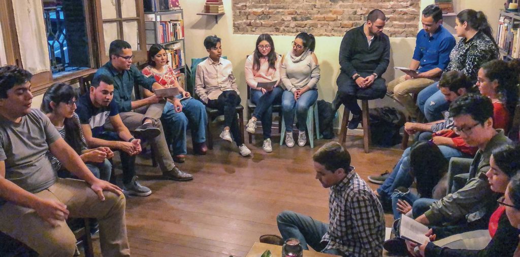 Members of the Redeemer Church of Christ and Venezuelan visitors sing during a devo.