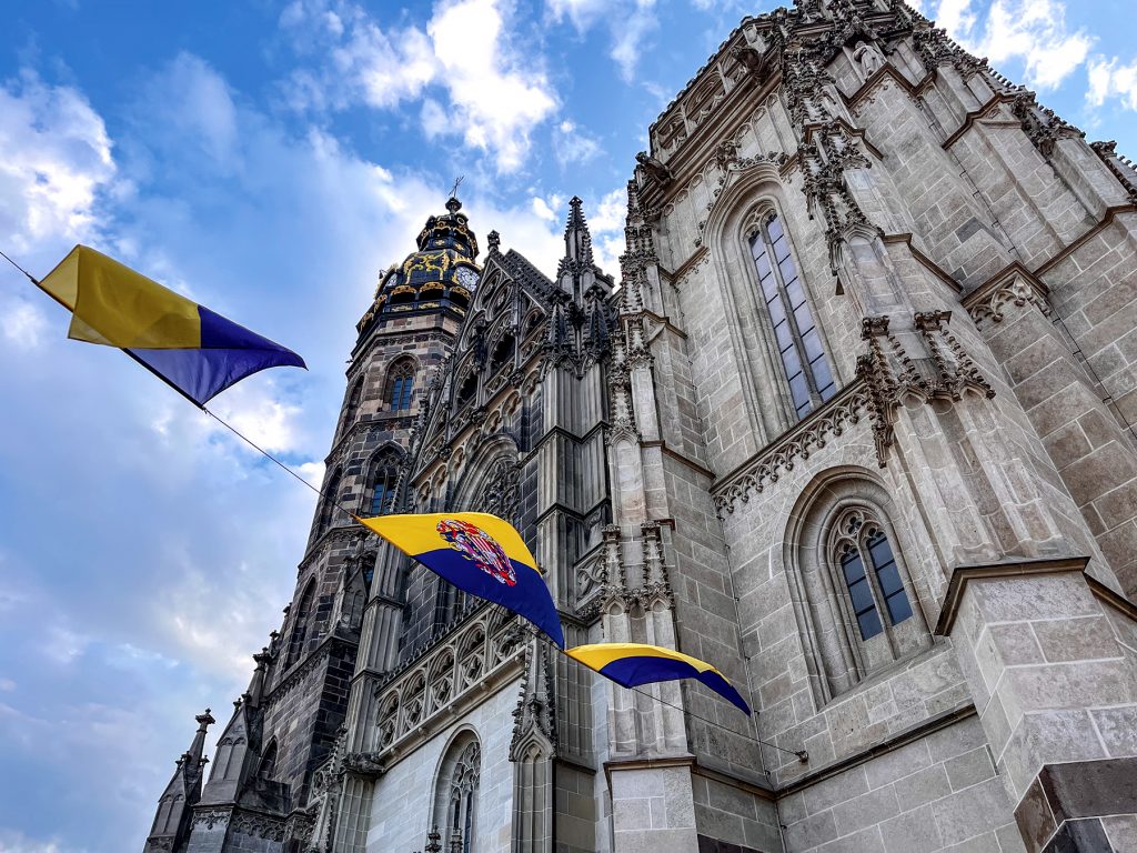 Flags of Košice, Slovakia, nearly identical to the flag of Ukraine, fly outside St. Elisabeth’s Cathedral in Košice, one of the easternmost Gothic cathedrals in Europe.