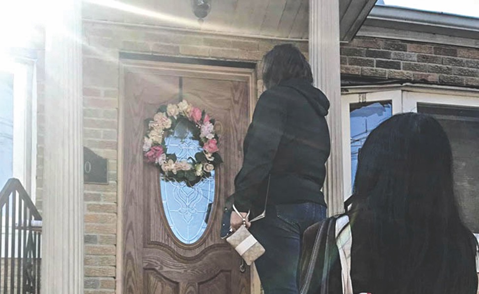 Members of the Long Island Church of Christ in New York knock on a door in their neighborhood during the first Brotherhood-Wide Door Knocking Day.