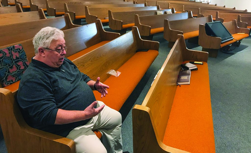 Minister Britt Farmer sits in the spot where he witnessed two of his fellow church members lose their lives Sunday.