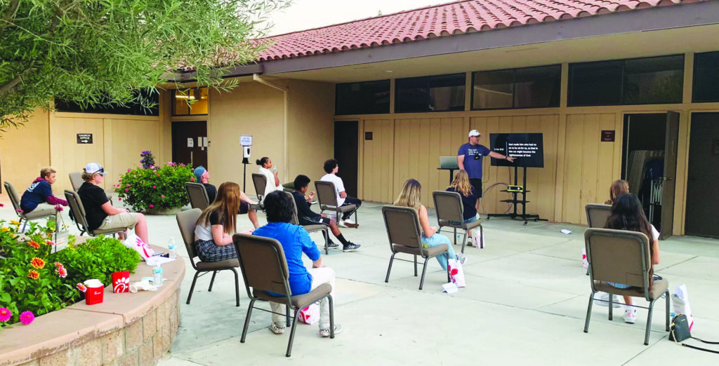 Students attend Bible class outside with plenty of spaces between chairs at the Mission Viejo Church of Christ, about 50 miles southeast of Los Angeles.