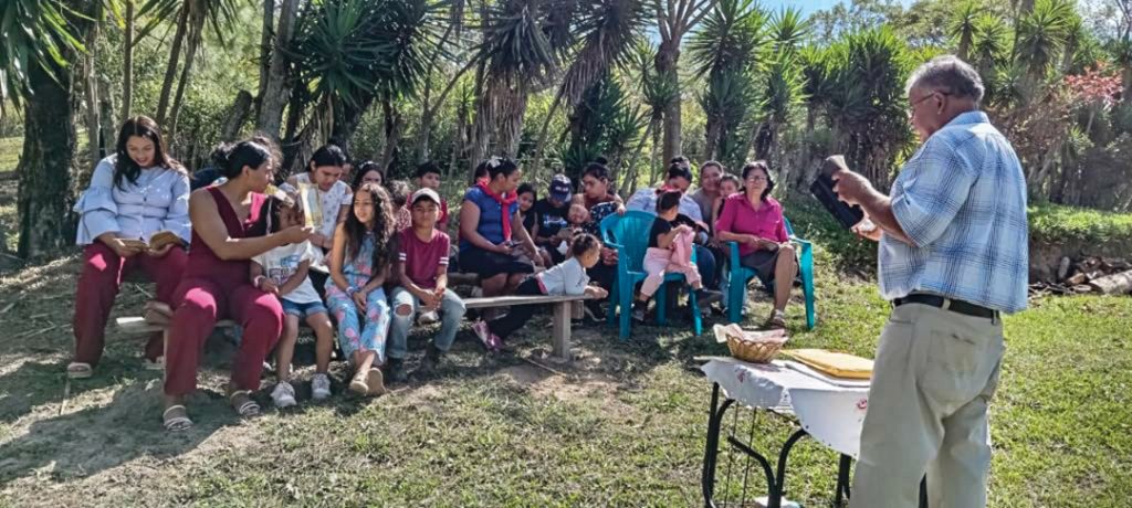 Rito Hernandez reads a Bible passage to his growing congregation in the community of Sabana Redonda, Honduras