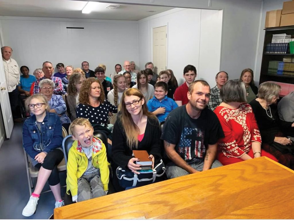 The Eastpoint Church of Christ congregation meets on a Sunday morning. The church, which has a regular attendance of 25 to 30, feeds children in the community.