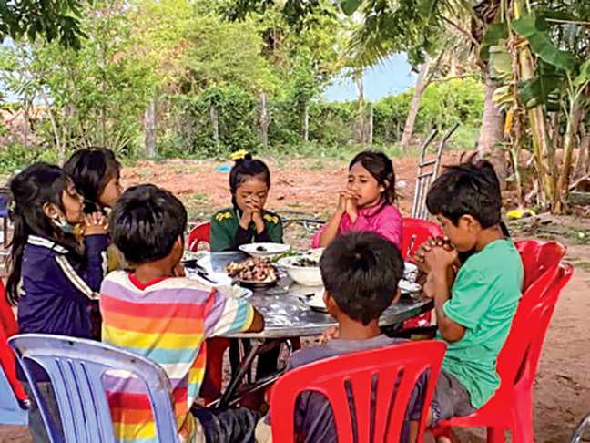 Children at an orphanage in the Kampong Leng district of Cambodia give thanks “for their daily bread.