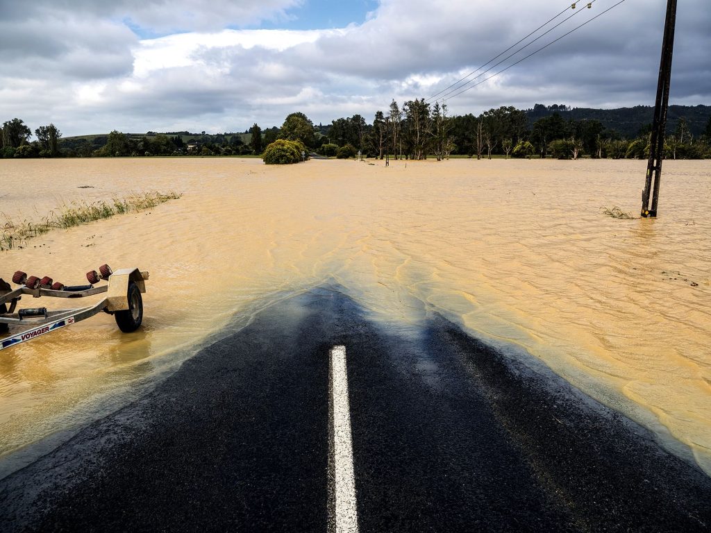 Muddy water covers a road in New Zealand after Cyclone Gabrielle. Prime Minister Chris Hipkins called it a weather event not seen “in a generation.”