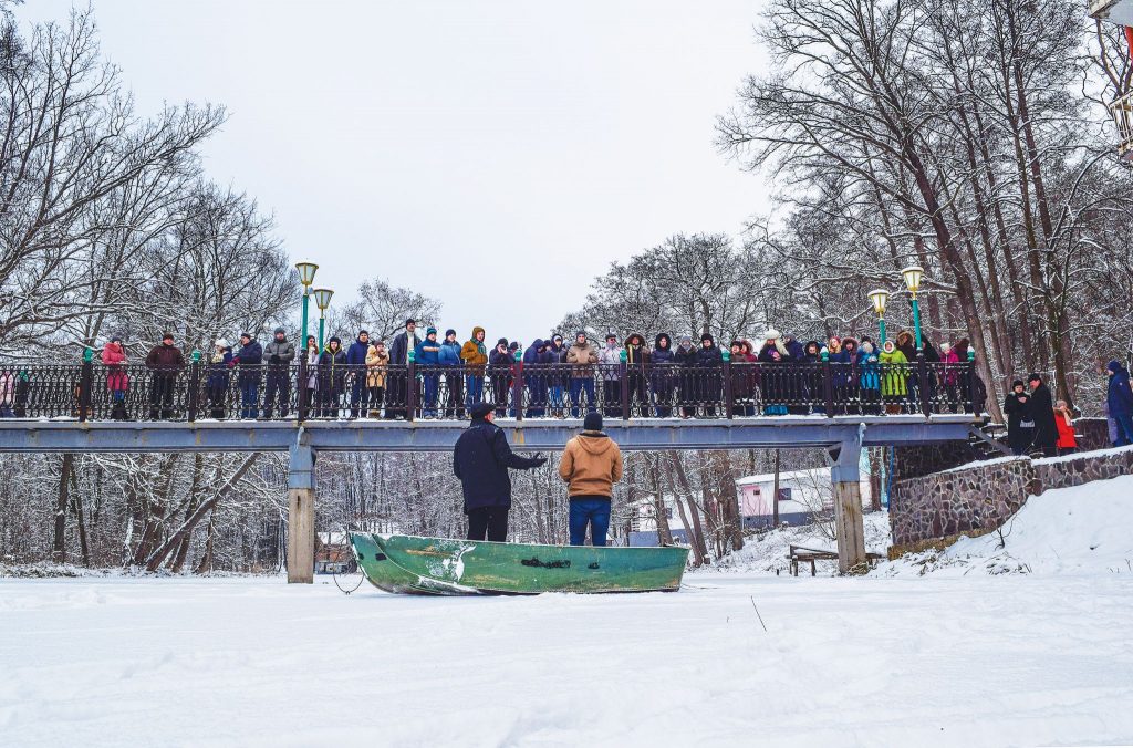 Standing on a boat in the middle of a frozen river, Jeff Abrams and translator Alexander Rodnaev preach during a retreat in the eastern Ukrainian city of Sviatohirsk, near the Russian border, in 2014. Abrams, minister for the Tuscumbia Church of Christ in Alabama, hopes to return.