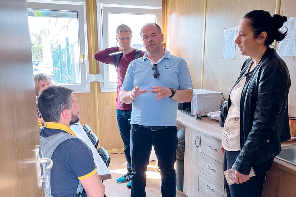 Peter Haluštok, center, talks to Romanian minister Adi Voicu, Brandon Price of the Ukrainian Bible Institute and Adela Liftakova, a city coordinator.