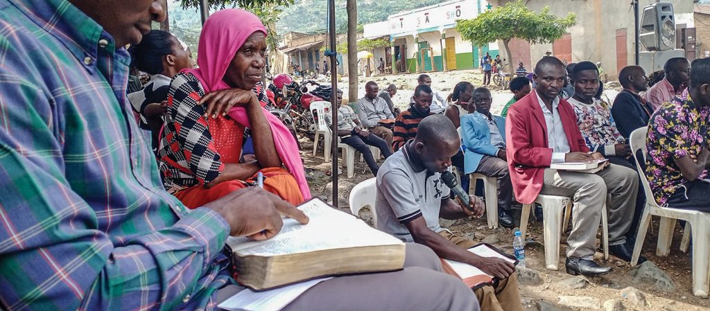 An open-air gospel meeting in rural Uganda.