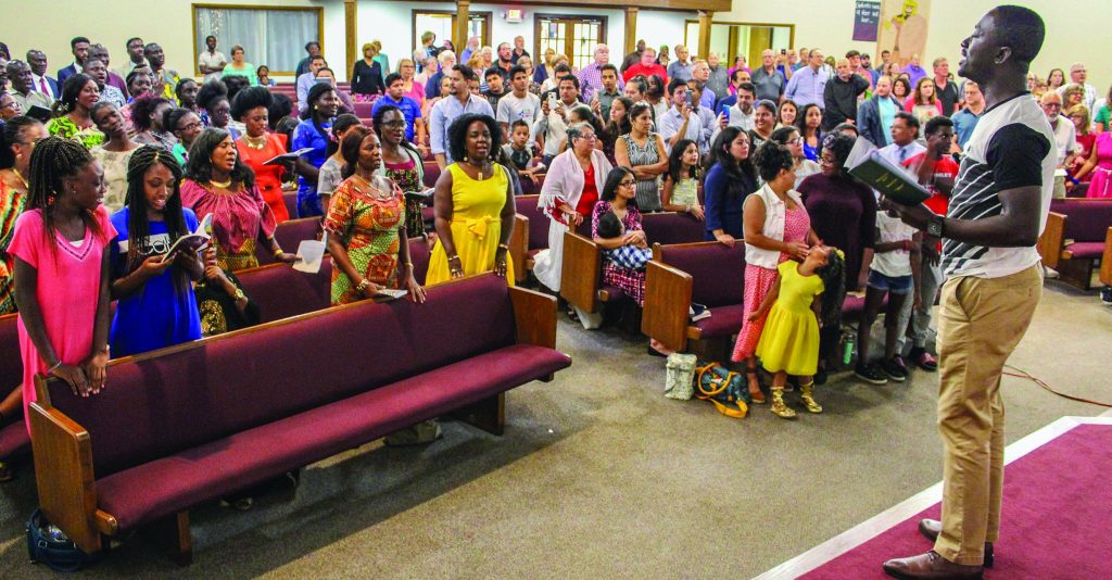 Asamoah Boateng leads the Twi dialect version of “Our God, He Is Alive” during the areawide service at the Northland Church of Christ.