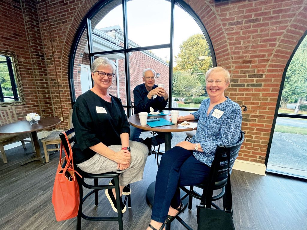 Cheryl Mann Bacon, left, visits with Mary Beth Shumate and her husband, Phillip.