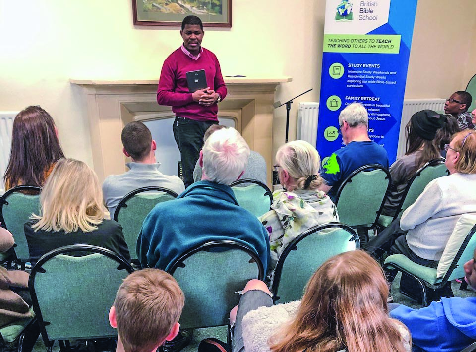 Sola Adeoson gives a communion devotional during the recent British Bible School Winter Family Retreat.