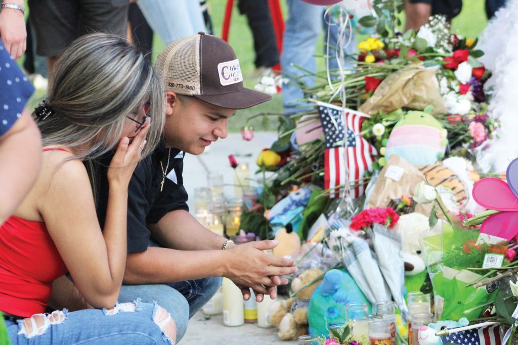 A couple grieves in Uvalde’s town square, about a mile from the shooting scene.