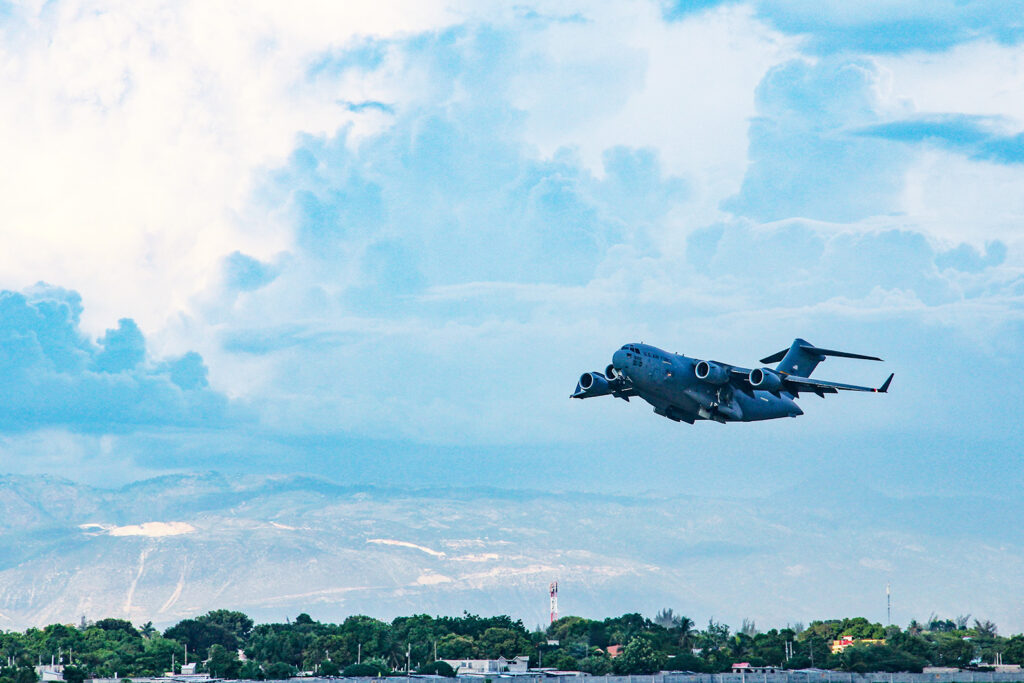 In Port-au-Prince, Haiti, an Air Force C-17 takes off after delivering aid.