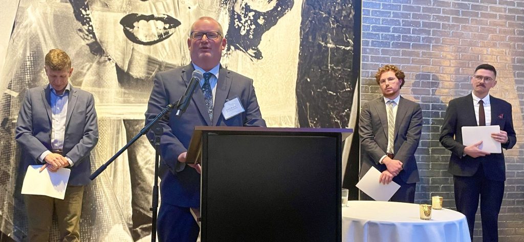 Bobby Ross Jr. accepts the Religion News Association's Supple Award for Feature Writing at a banquet in Pittsburgh.