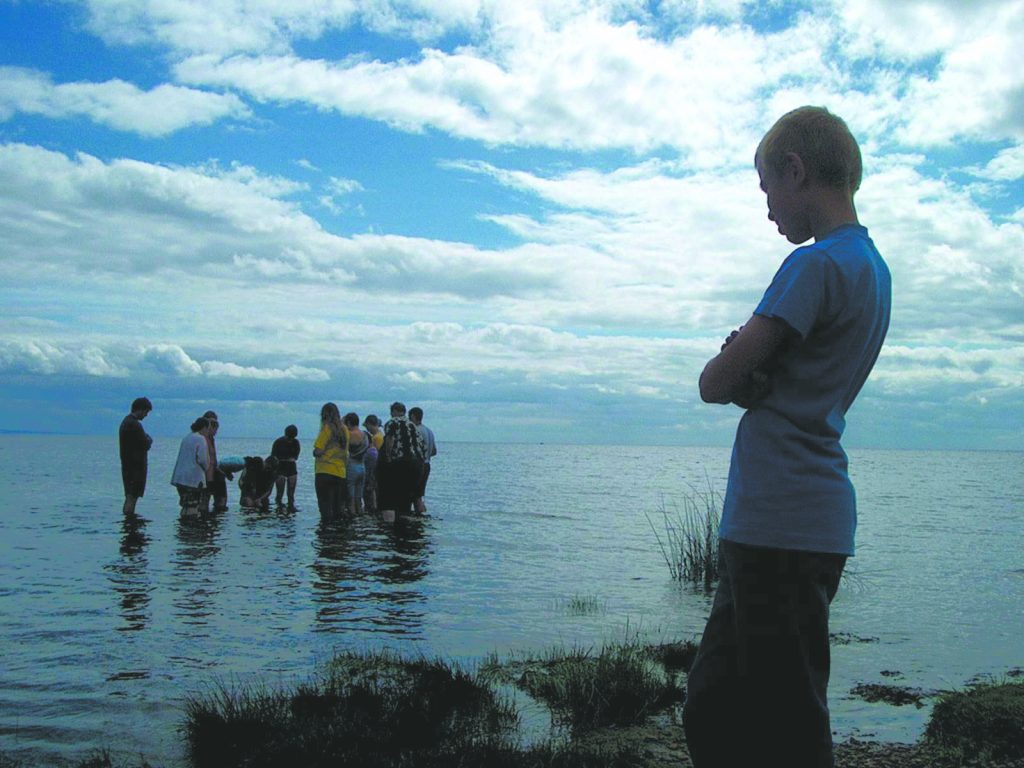 A Russian youth is baptized in the Gulf of Finland near St. Petersburg in 2002.