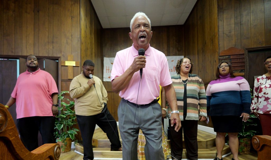 Harold Carr, chair of the 24th annual homecoming reunion of the West End Silver Point Church of Christ, leads a group during a Saturday song fest.