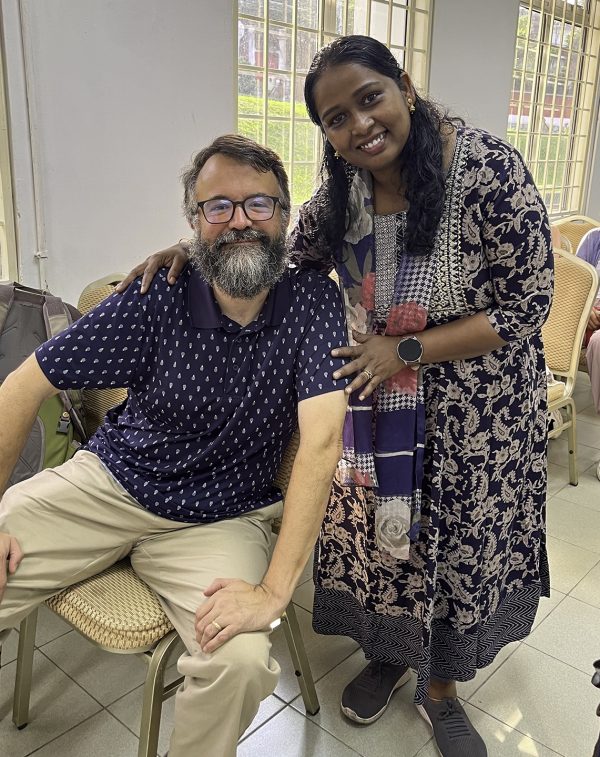 Erik Tryggestad and Betty Chukka smile before Sunday worship with the Seremban Church of Christ.