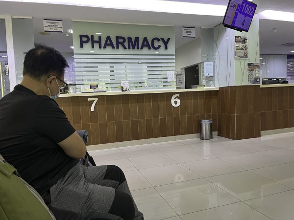 Tan Beng Chuan waits with Erik Tryggestad at the CMH Specialist Hospital in Seremban, Malaysia.