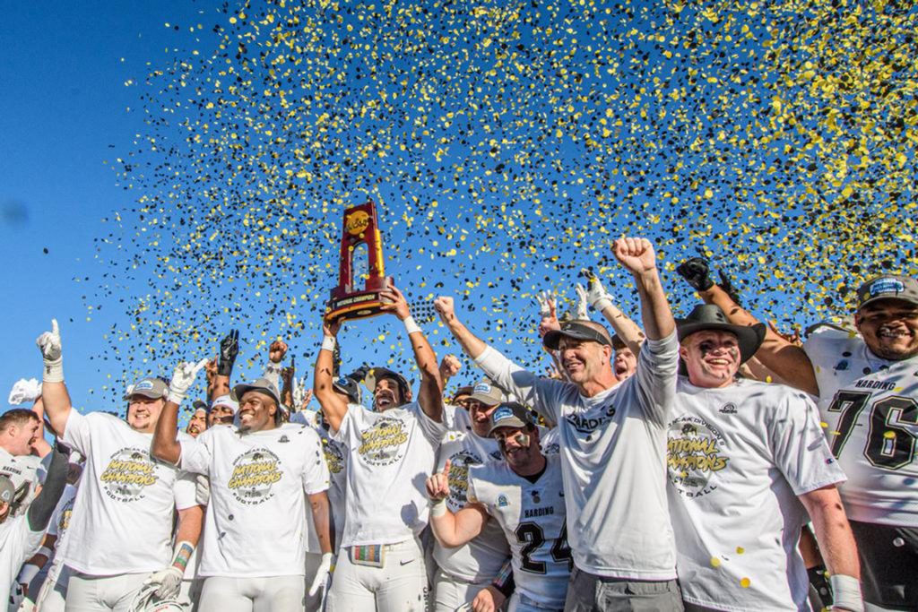 Coach Paul Simmons and his Harding University Bisons celebrate their Division II football national championship in McKinney, Texas.