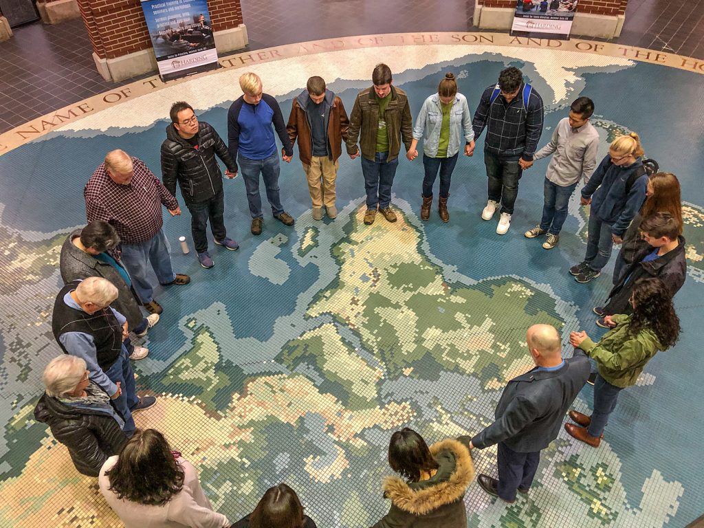 Students, faculty and friends at Harding University in Searcy, Ark., pray Tuesday for China and the growing threat of the Coronavirus. They gathered in the McInteer Bible and World Missions Center.