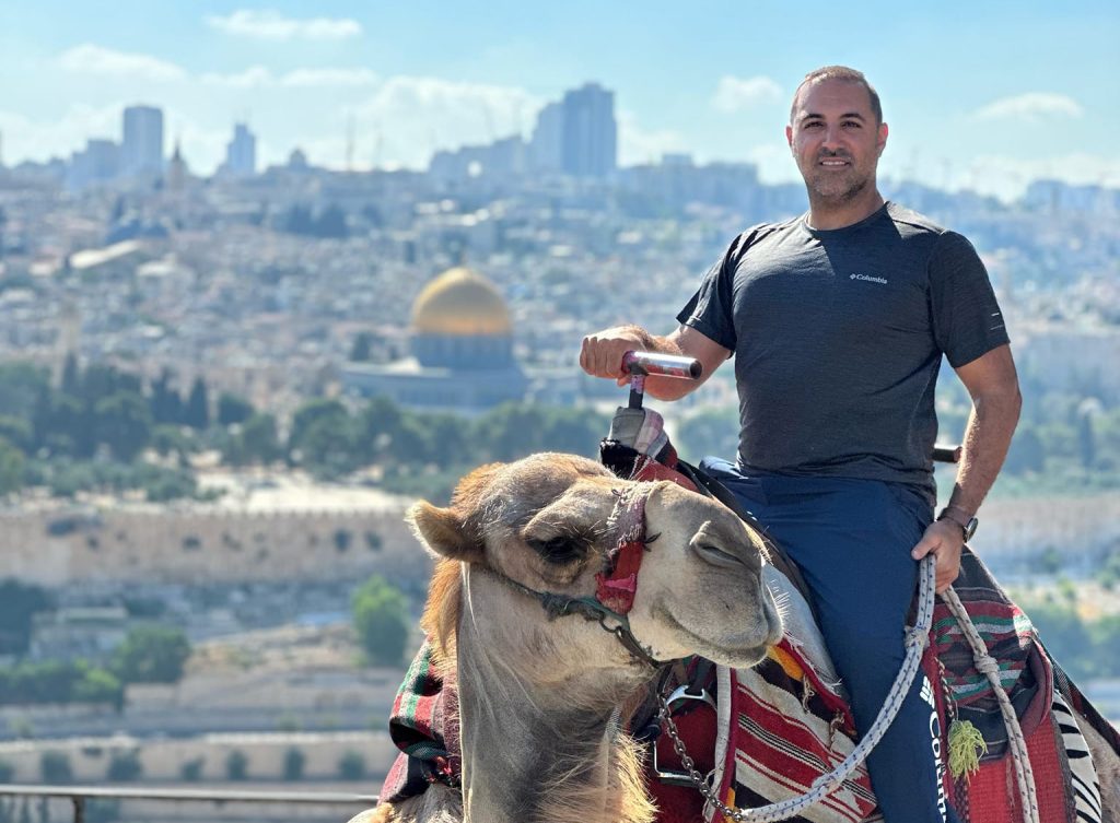 Arab Israeli Christian and Holy Land tour guide Sandro Jadon takes visitors to historic sites — and occasionally provides camel rides.