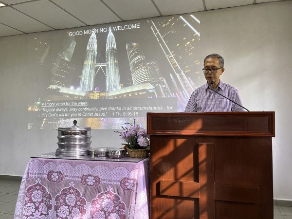 Kenneth Gong welcomes visitors during Sunday worship in Seremban, Malaysia.