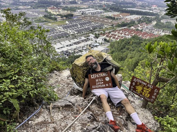 Erik Tryggestad attempts to catch his breath at the top of Kepayang Hill.