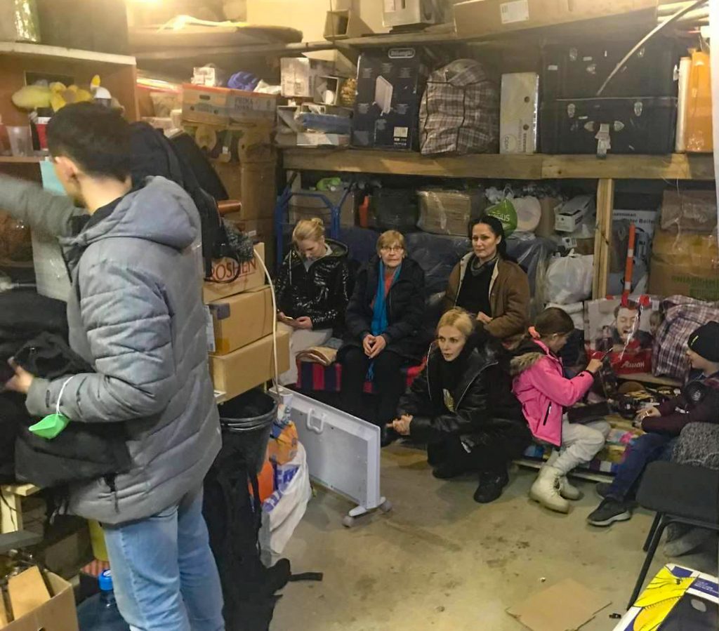 Church members take shelter in the basement of the Ukrainian Bible Institute in Kyiv, Ukraine, as planes fly overhead.